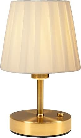Brass table lamp with pleated cream fabric shade and round brass base