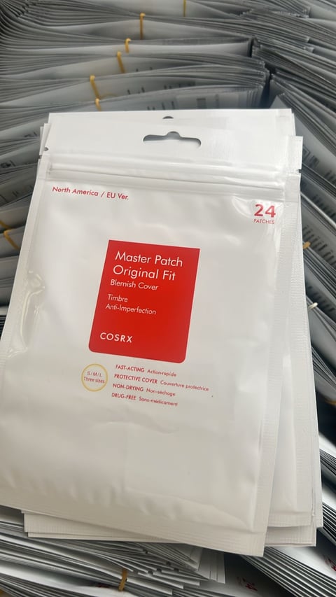COSRX Master Patch Original Fit acne stickers package with 24 patches displayed on a shelf with other skincare products