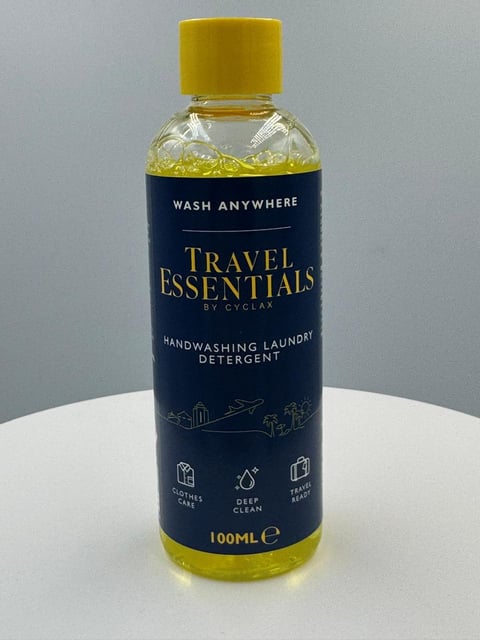 Bottle of Travel Essentials handwashing laundry detergent by Cyclar with yellow cap and label, 100mL size