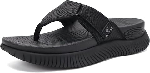 Black thong sandal with textured straps and cushioned sole featuring ribbed design on white background