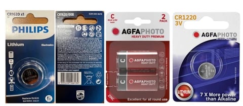 Four button cell batteries displayed with packaging showing Philips lithium CR1620, Agfa Photo batteries in red and blue packages