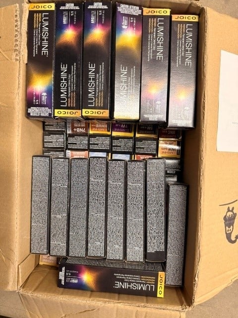 Cardboard box filled with Joico Lumishine hair color boxes arranged in rows